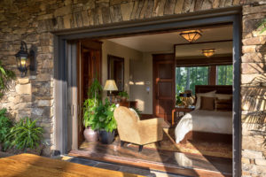 Guest bedroom with vanishing pick doors to outdoor patio