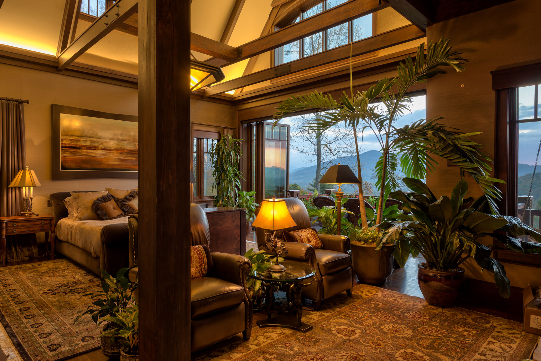 Master bedroom suite with folding outdoor doors and vaulted ceiling