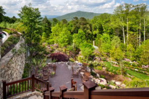 Mountainside, terraced seating area next to waterfall