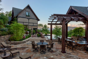 Outdoor Entertaining with a view of Downtown Asheville. Stone patio, outdoor kitchen, bar, infinity edge, mountain-side pool