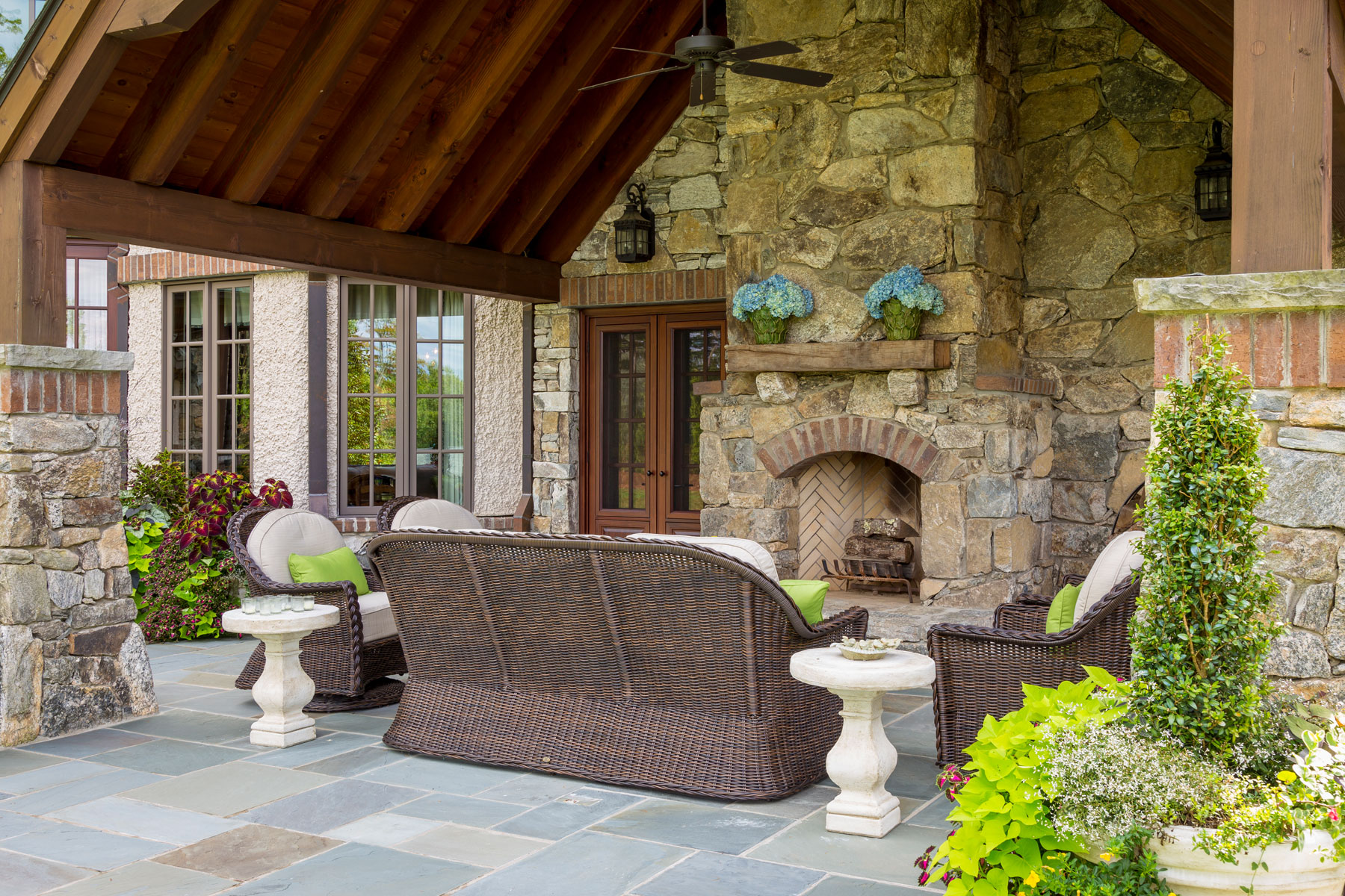 Outdoor room with fireplace and seating area on vaulted ceiling