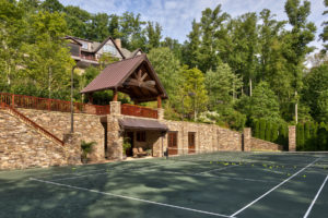 Courtside pavilion for tennis matches. Stacked stone, mountain