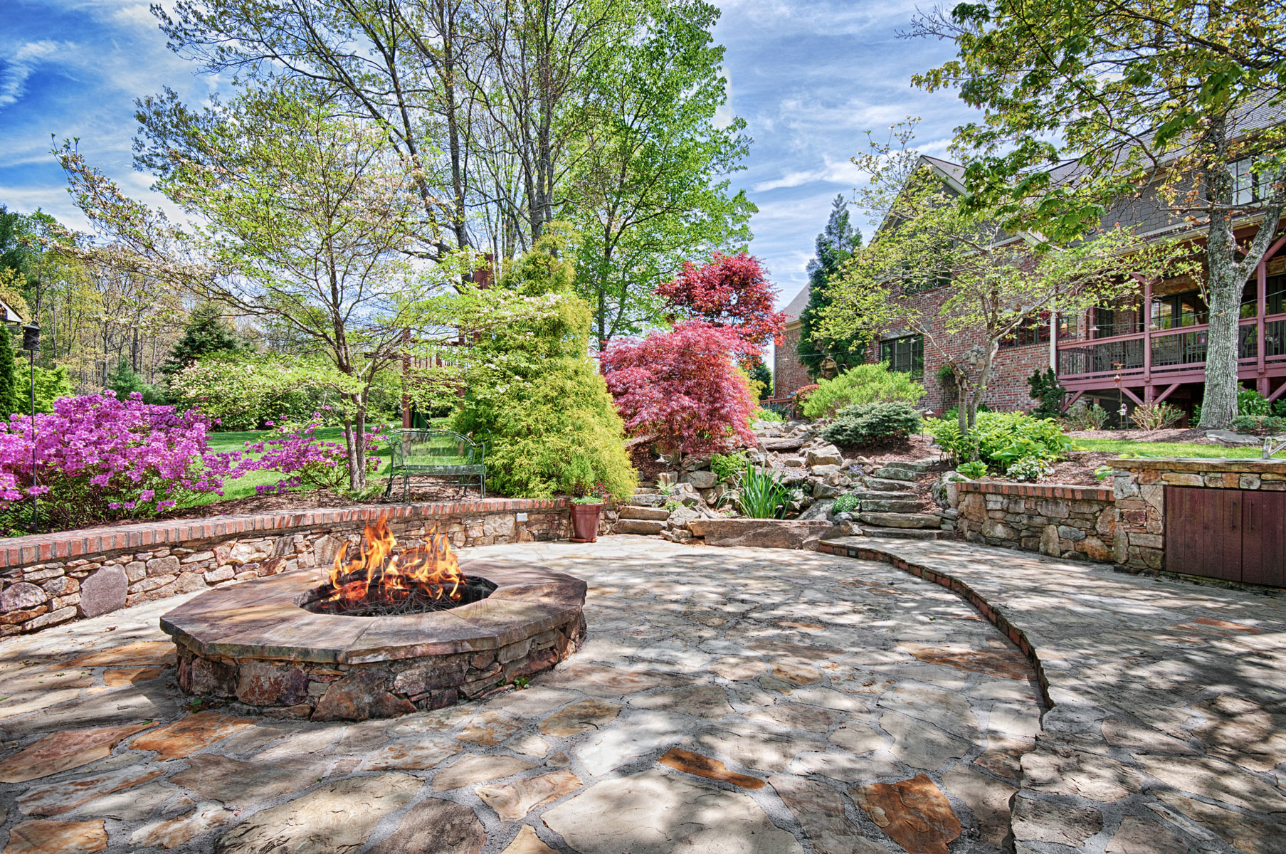 Rear yard with stone patio and firepit