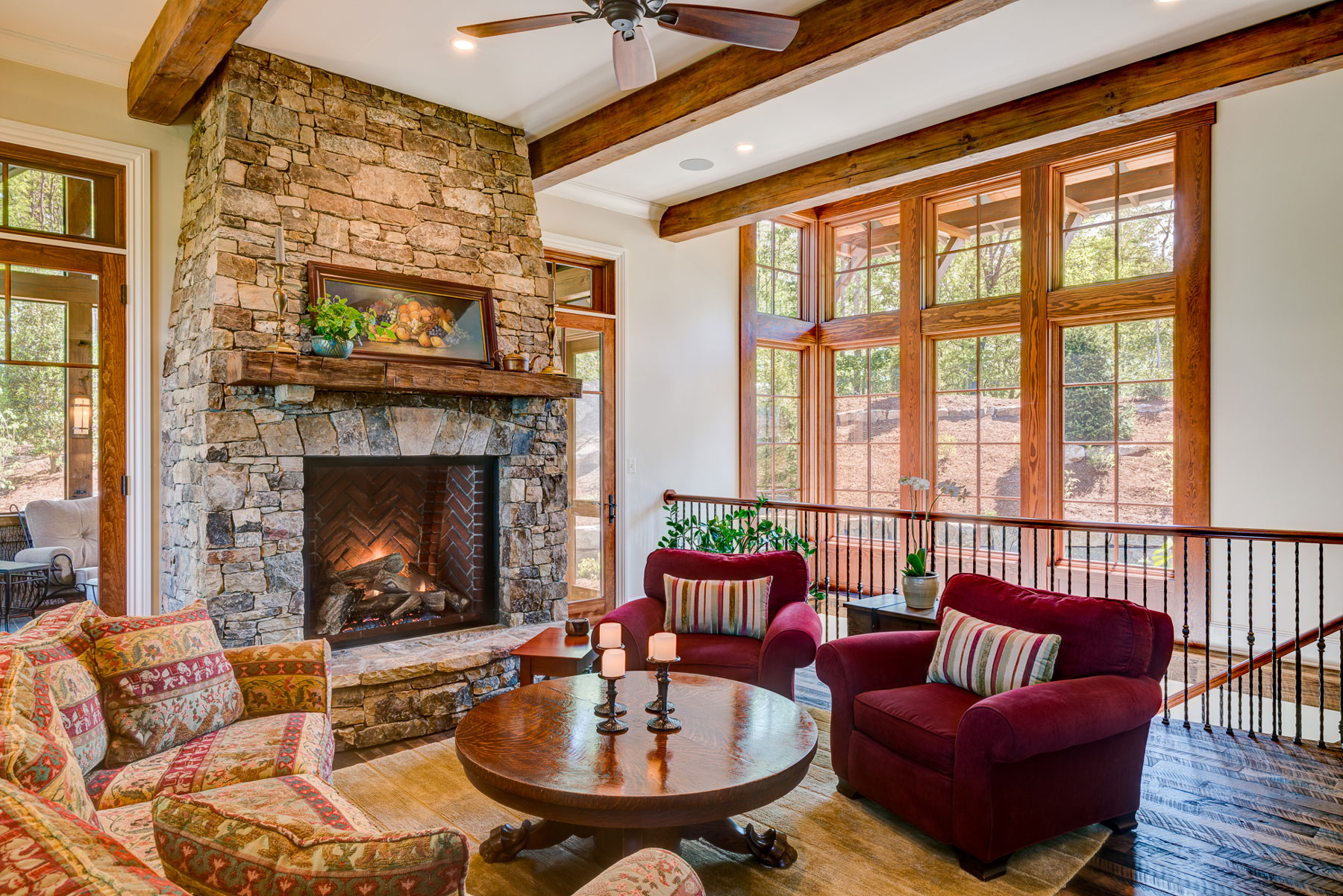 stone-fireplace-den-with-open-staircase-to-basement