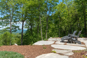 Adirondack chairs set at mountains edge to take in the views