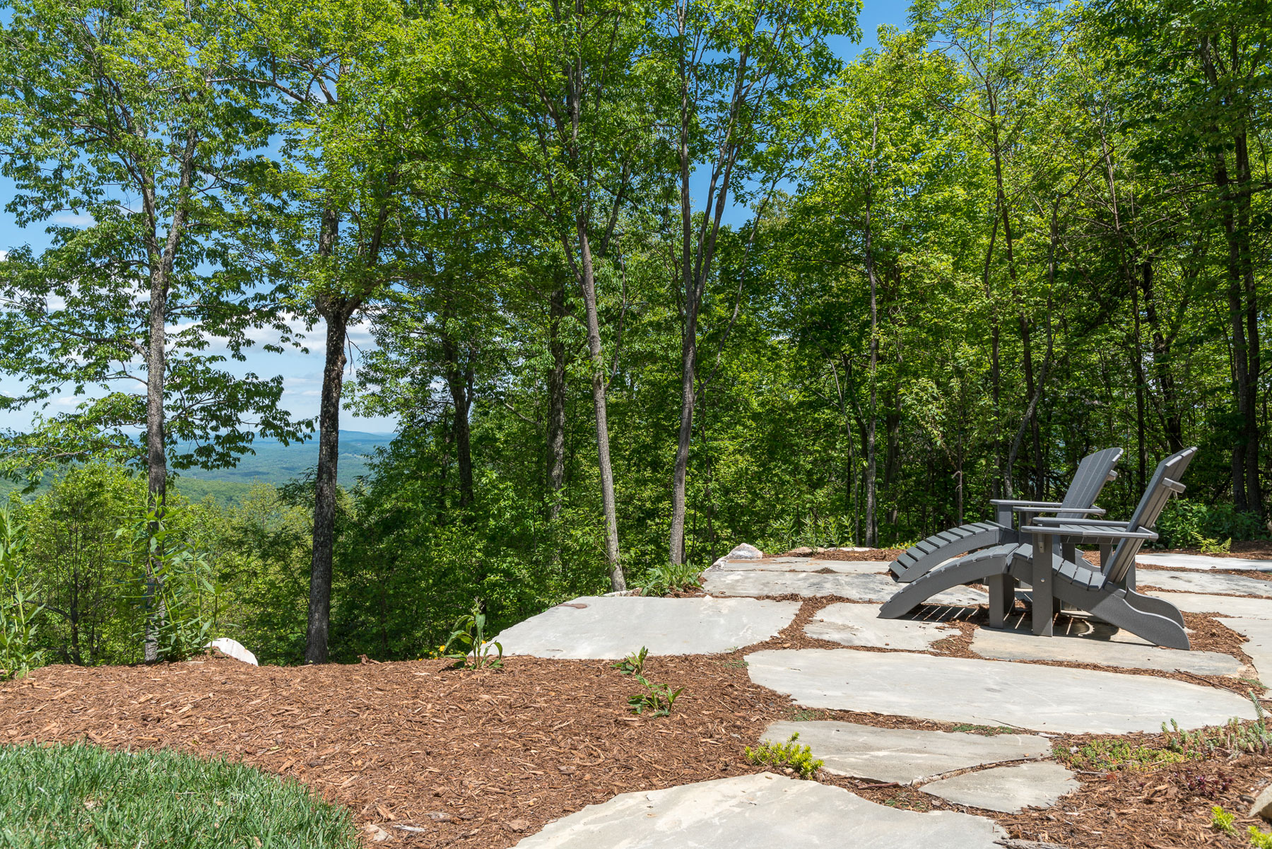 Adirondack chairs set at mountains edge to take in the views