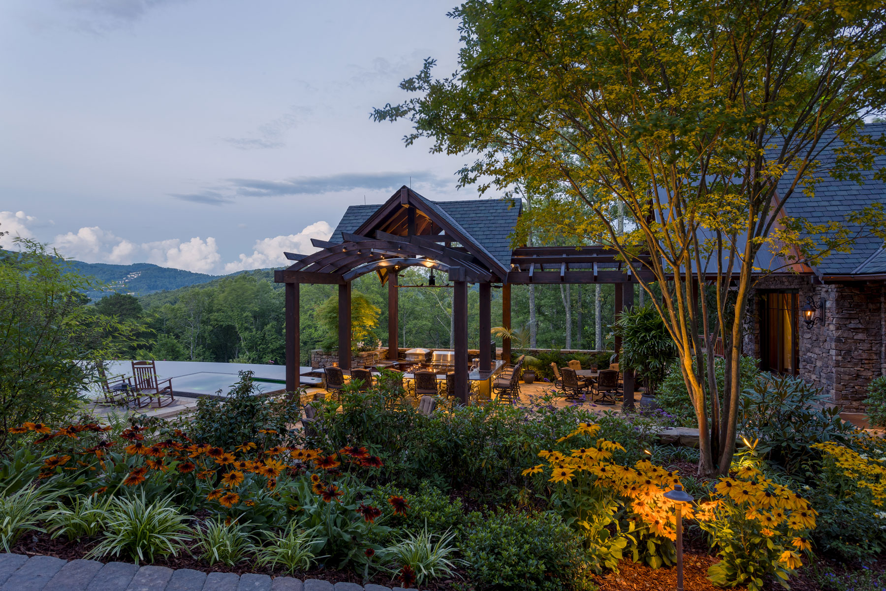 Outdoor kitchen pavilion made of timber and stone in luxury home renovation in Asheville