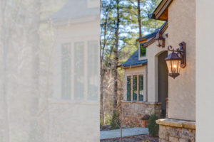 Exterior detail: light fixtures and stone work on stucco european romantic style home in Biltmore Forest