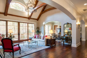 Formal living room with vaulted ceiling with timber beams