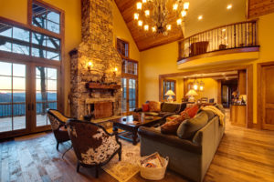 Two story family room with stone fireplace in custom designed home