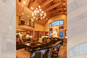 Large family room with vaulted, wood clad ceiling, open to kitchen in luxury mountain home