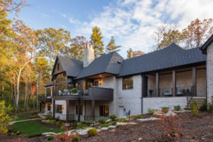 Back of new custom home with walkout-basement, porches, and lower level patios