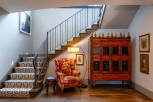 Custom furniture at the bottom landing of the staircase