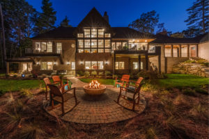 Custom designed mountain home with outdoor living area including firepit