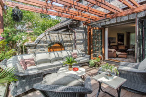 Patio with vintage stone work walls and new trellis to create outdoor living area