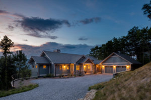 Sunset view of custom mountain craftsman with traditional and modern details