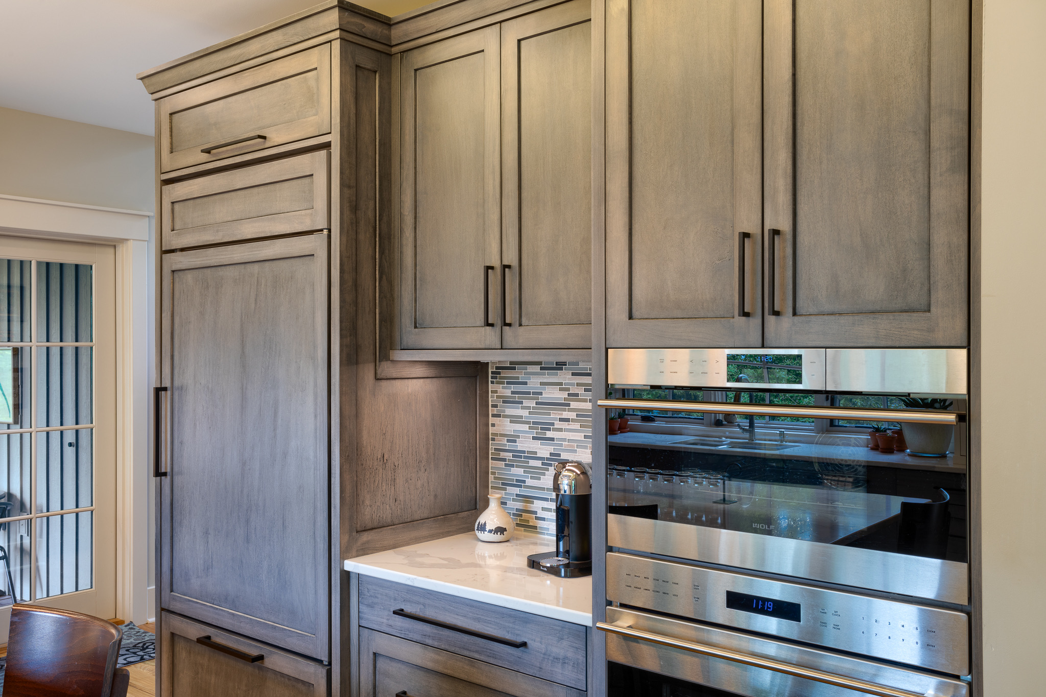 Appliance wall in new modern, rustic kitch with gray cabinets