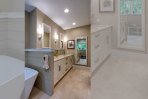 Master bath with double vanity and tile backsplash