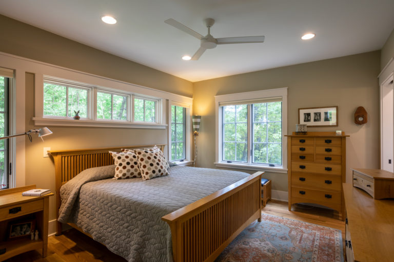 Master bedroom with transom windows over the bed ACM Design