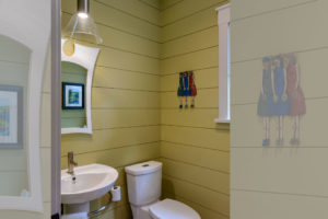 Powder room with yellow shiplap