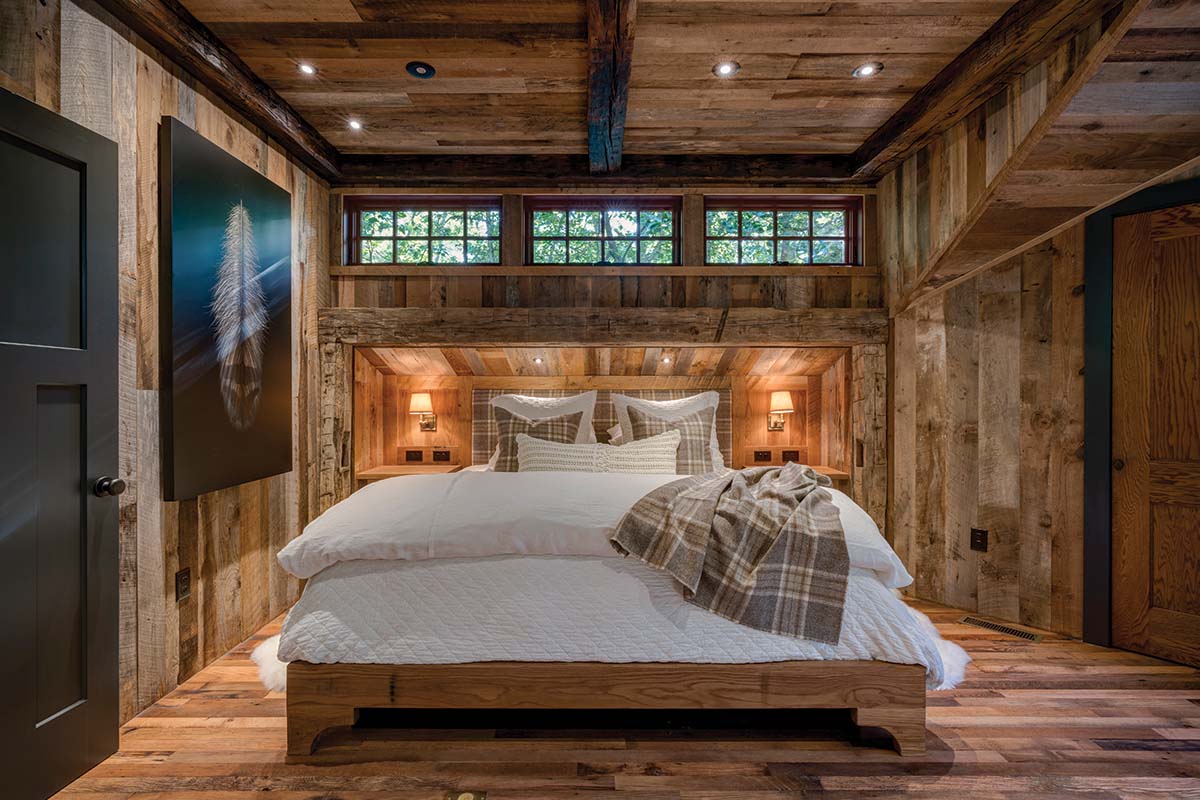 Bespoke design with character in a small space using reclaimed barnwood on the bedroom walls