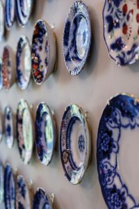 Blue Flow ceramics collection of plates hung on kitchen wall