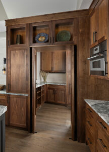 Creating smart storage out of sight in hidden pantry concealed behind cabinet doors