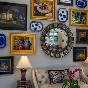 Feature wall displaying art collection of curated personal art