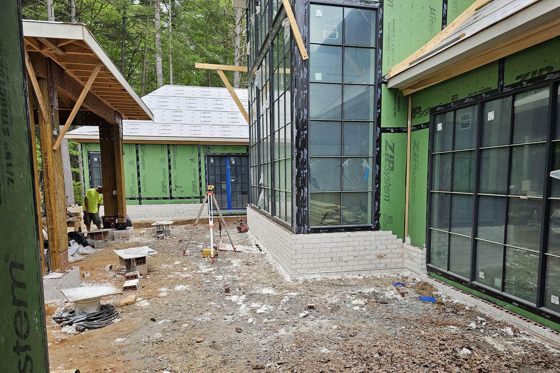 Exterior white brick work applied to facade of home with extensive walls of windows.