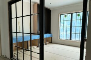 Custom cabinetry install with black painted finish for library and office