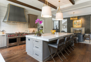 Artisan-designed vent hood in matte zinc with brass accents