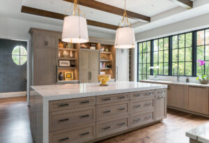 Large center island custom designed cabinetry in white oak with riff cut.