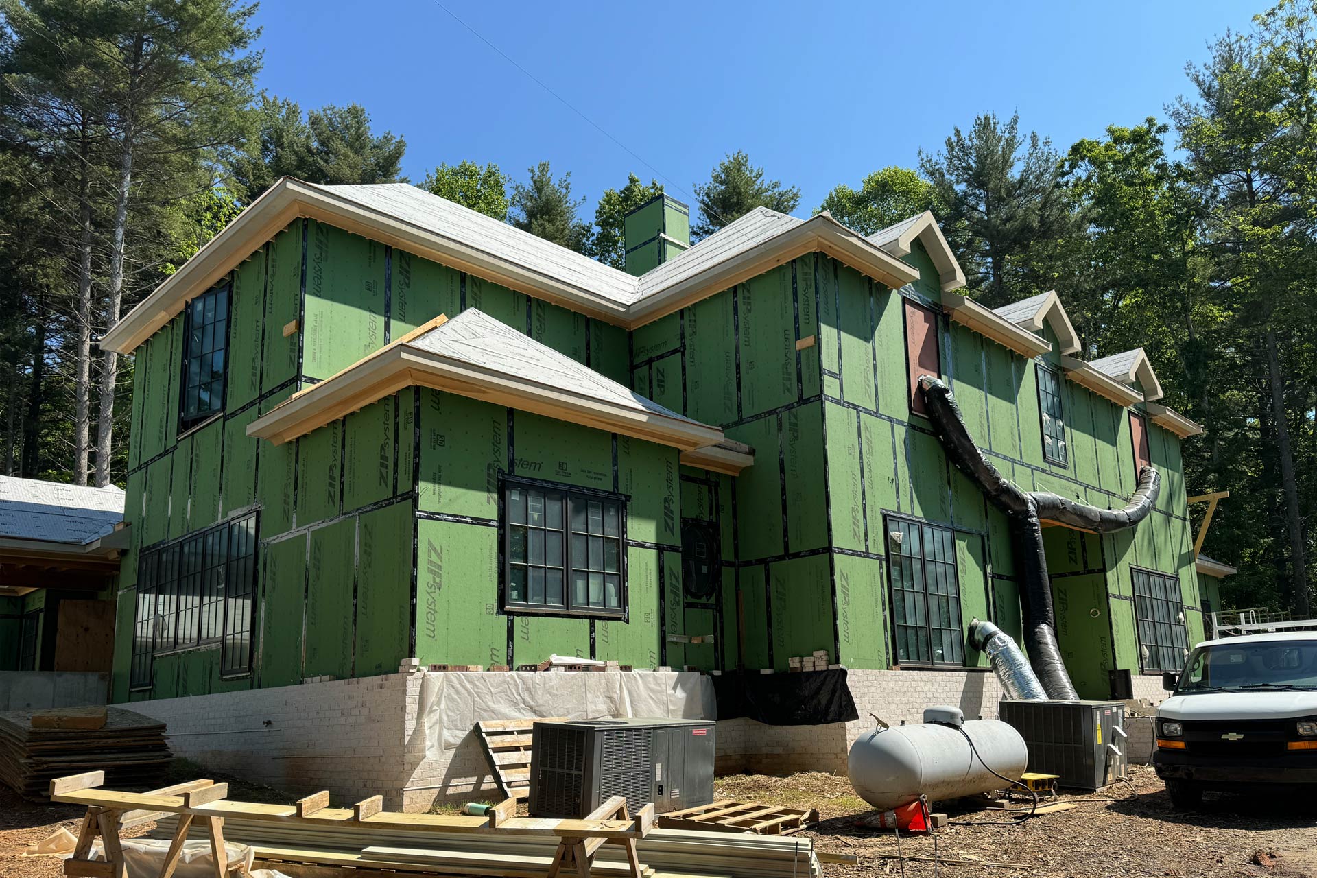 Front elevation of French Manor home design by ACM Design architecture for luxury new home under construction in Asheville, NC