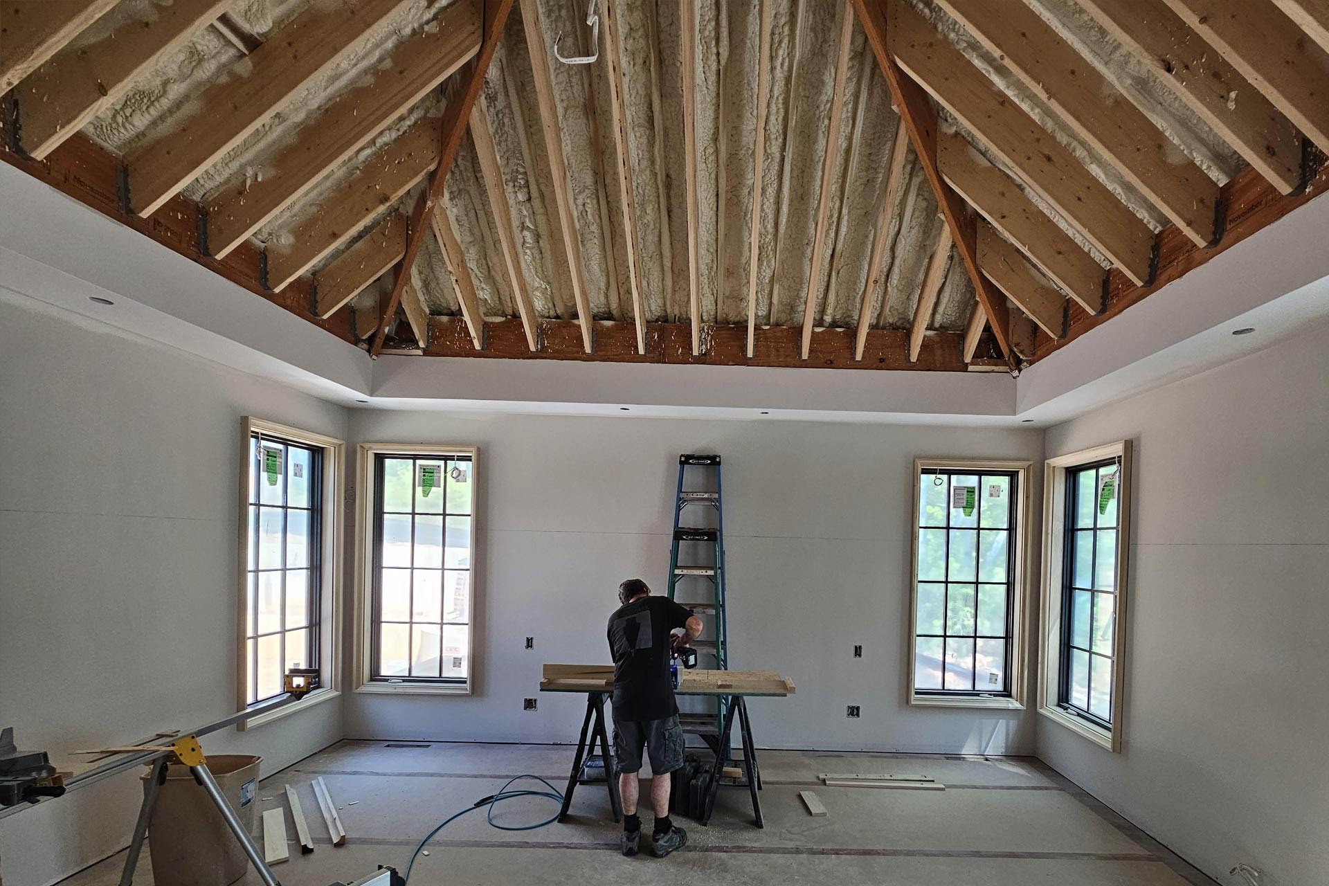Finishing work in owner's suite with vaulted ceiling of new French Manor home designed by ACM Design.