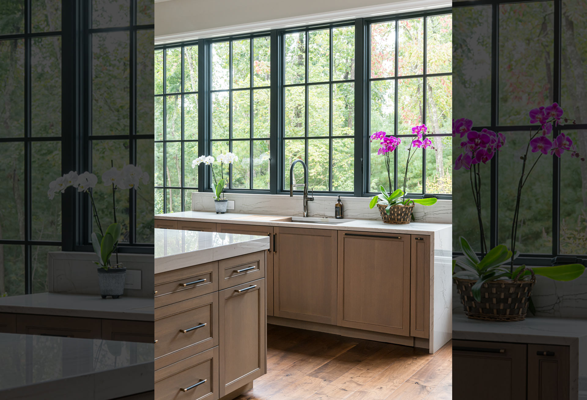 Custom designed kitchen in Asheville home with unique wall of windows design surrounding sink base