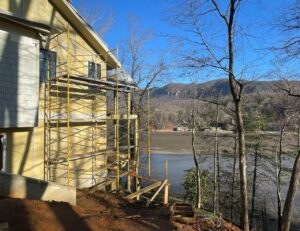 Side view with lake view and mountainside lake cottage built on slope