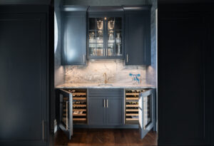 Wine bar with painted ink blue cabinets with dual sub-zero wine refrigerators