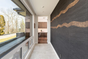 Handmade Élitis wallpaper lines hallway of modern mountain home renovation