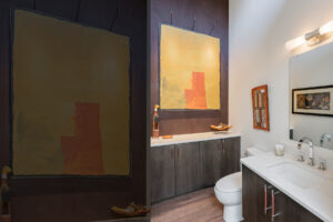 Creating a gallery space in the main floor powder room to display art collection.
