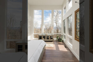 Primary suite with wall of windows to mountain view