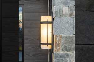Rustic mountain charm of exterior light fixture against stacked stone