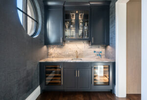 Wine bar with painted ink blue cabinets with dual sub-zero wine refrigerators