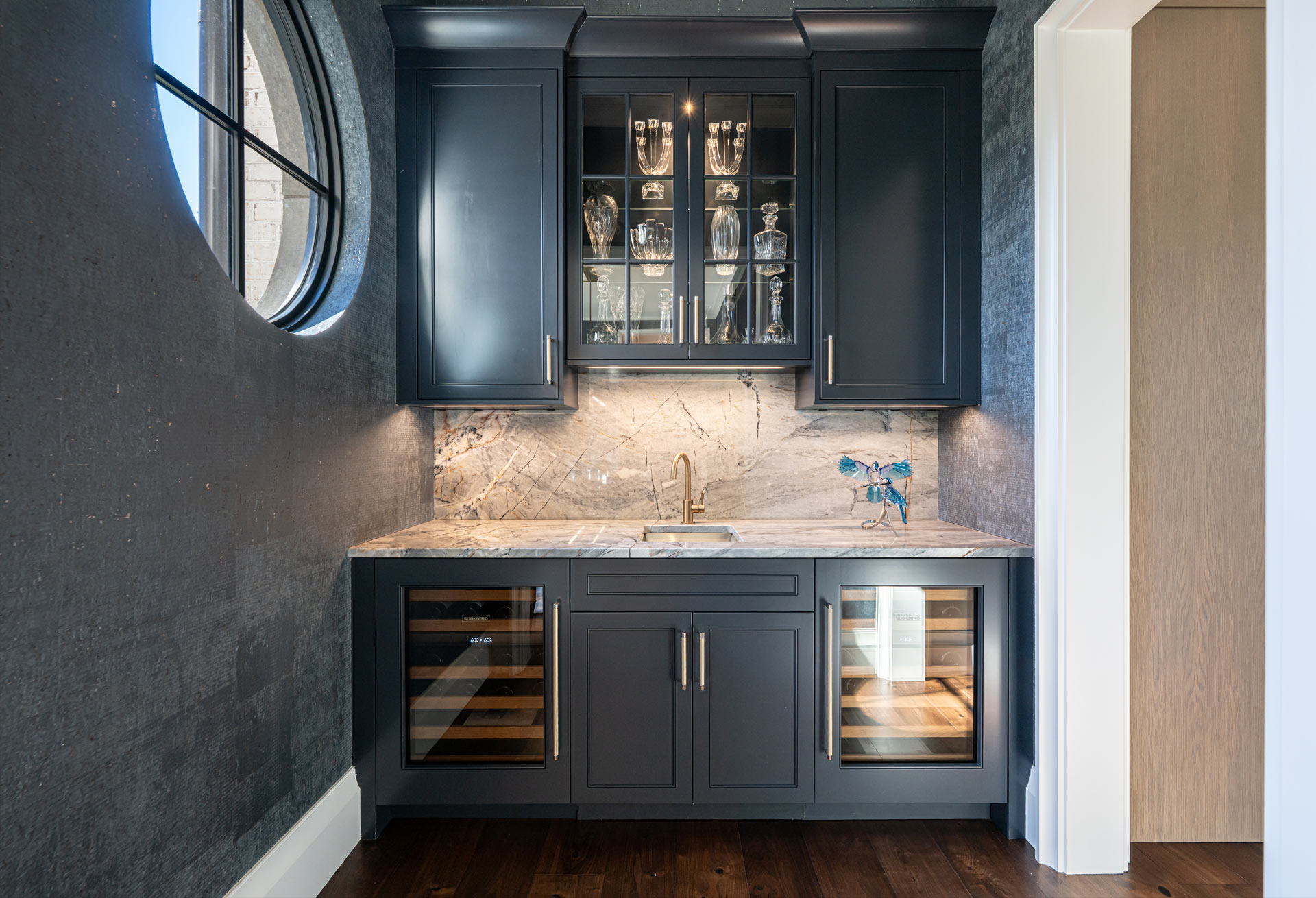 Wine bar with painted ink blue cabinets with dual sub-zero wine refrigerators