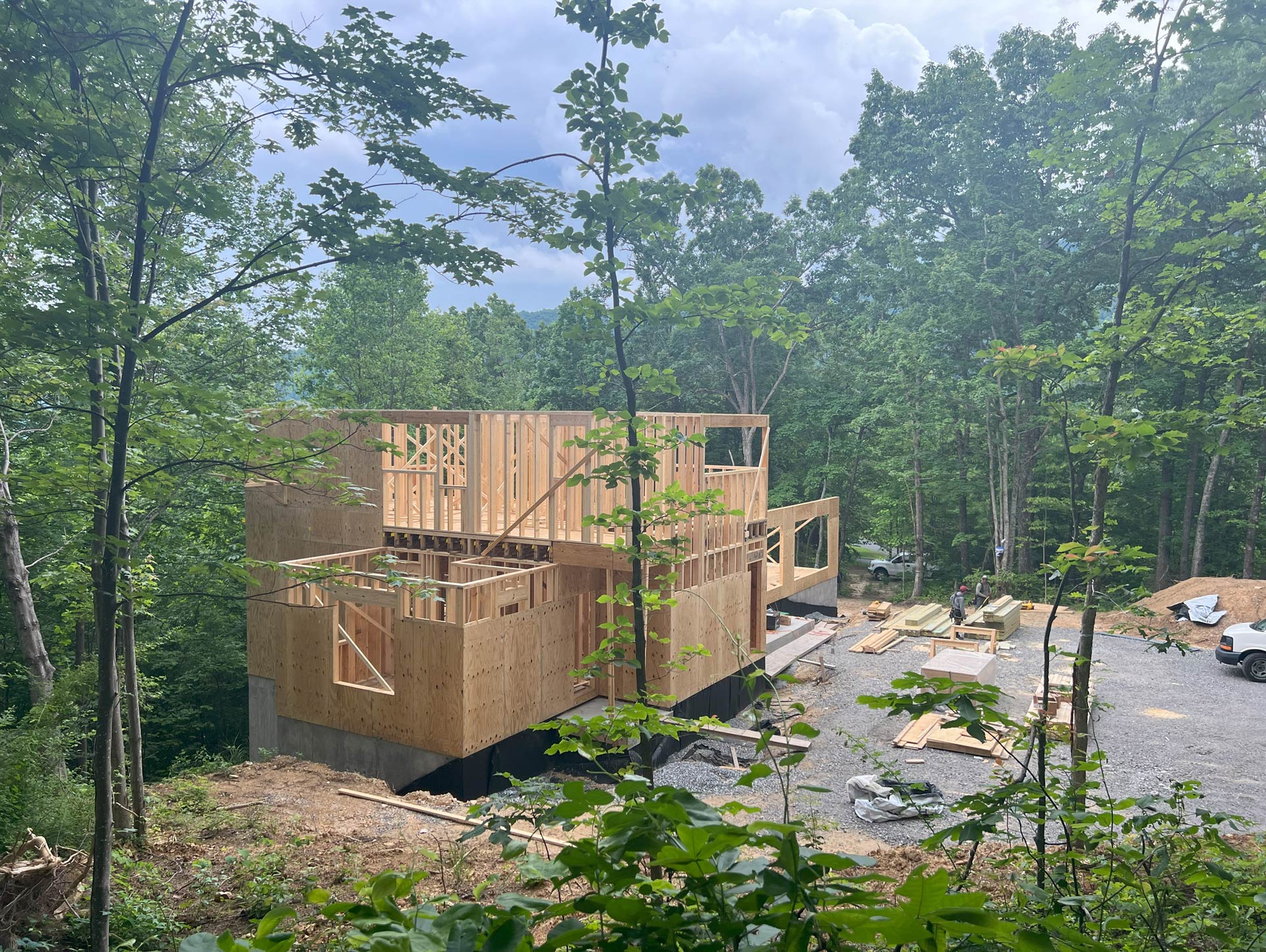 Modern and rustic family retreat home under construction in Black Mountain, NC by architect ACM Design