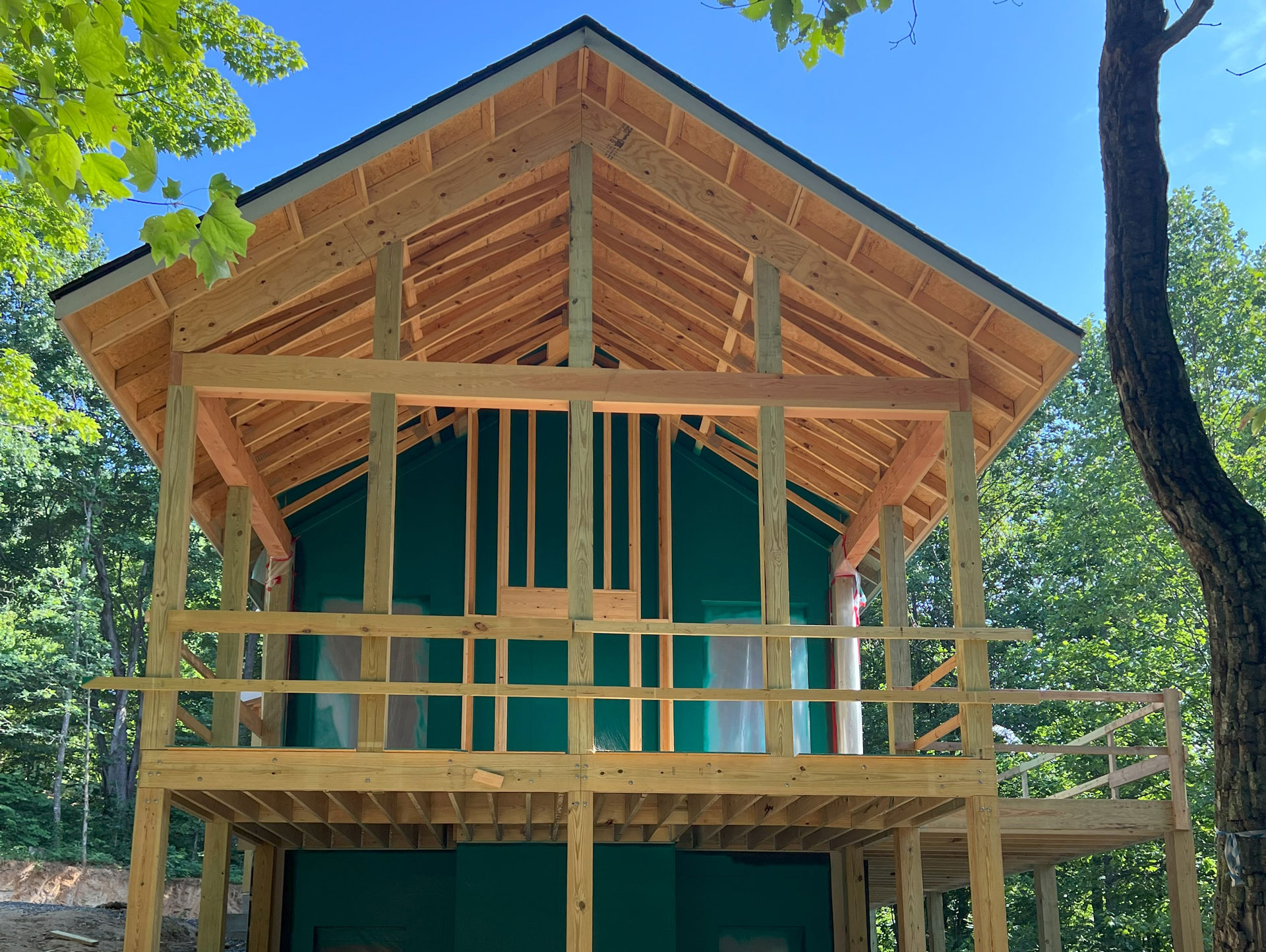 Large covered screened room porch on mountain home in the framing stage. 