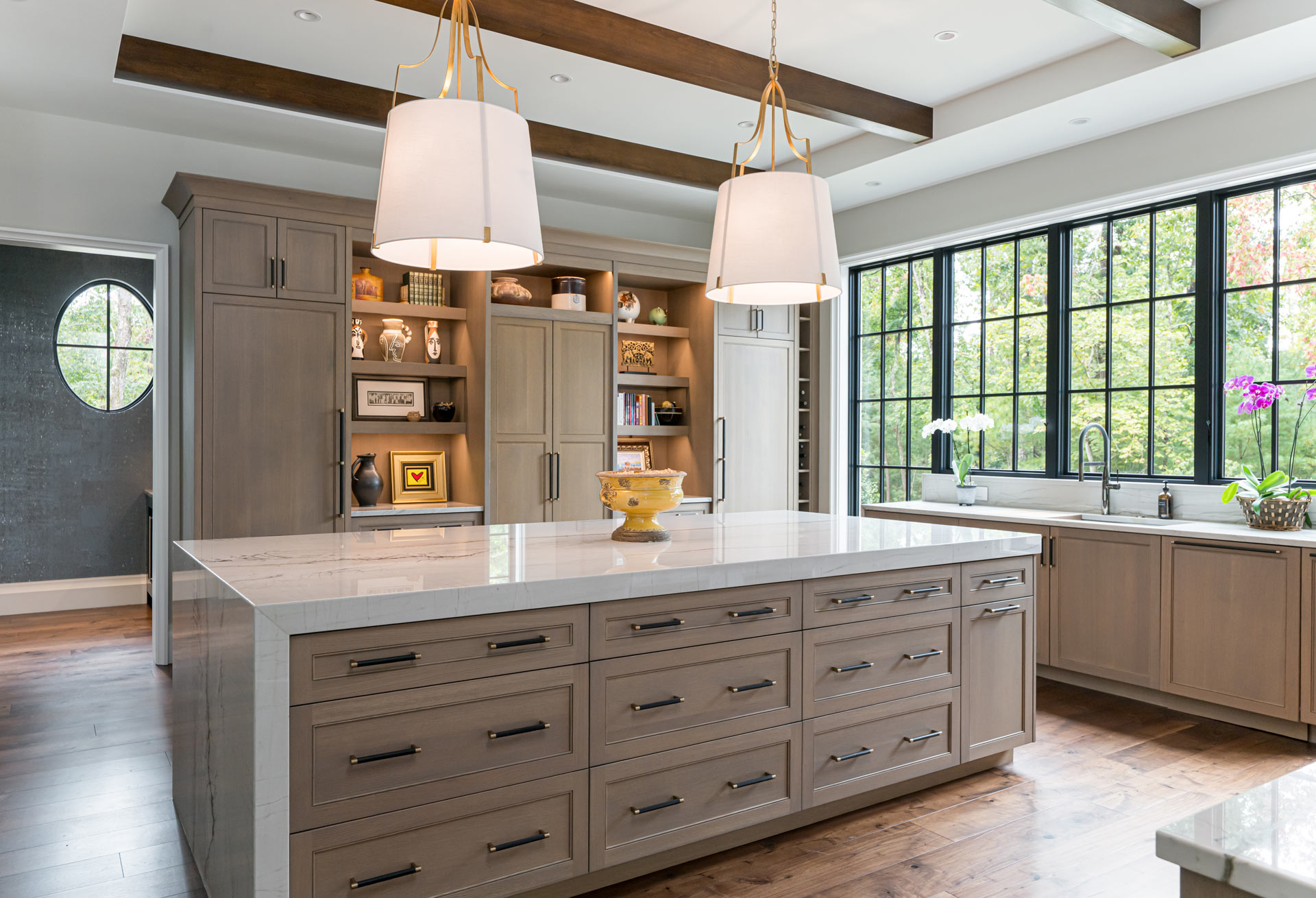 Large center island custom designed cabinetry in white oak with riff cut.