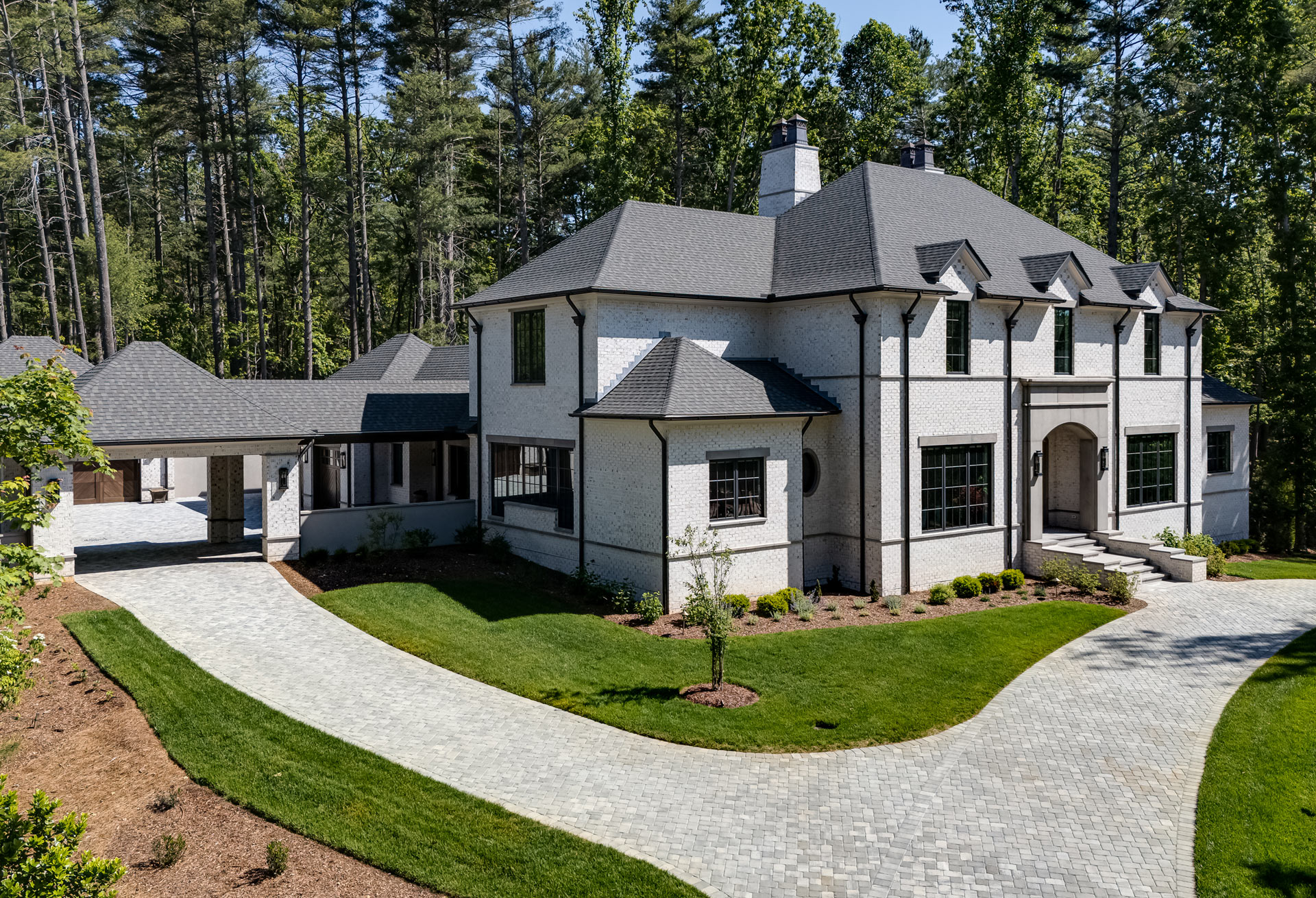 circular-front-drive-white-brick-manor-home